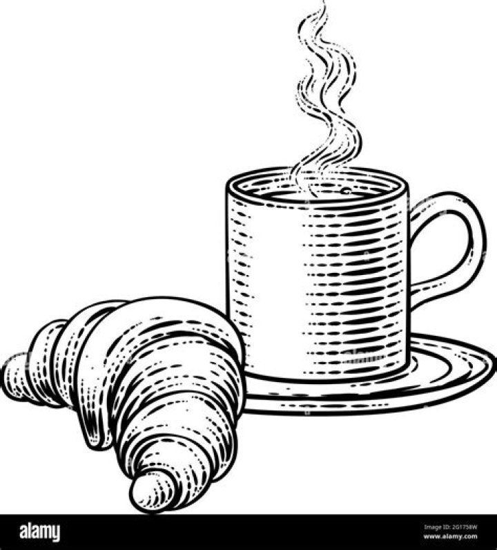 A croissant and cup of coffee on a cafe table in Austria