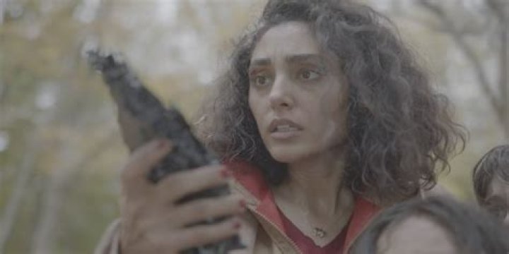 Aneesha holds an alien claw in Invasion