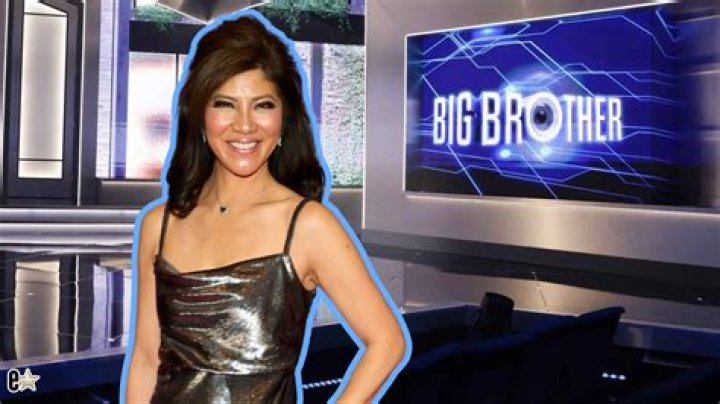 Big Brother host Julie Chen Moonves wearing a Santa hat and smiling next to the Big Brother Reindeer Games logo