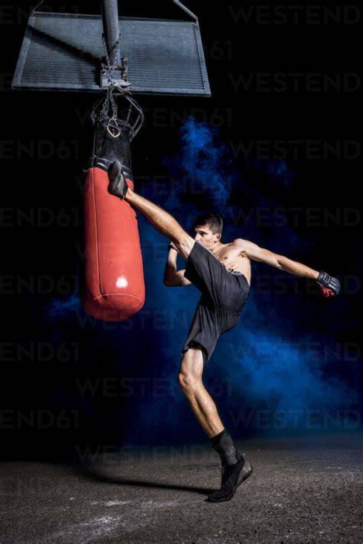 Boxer exercising with punch bag