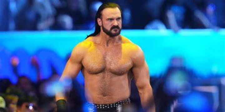 drew mcintyre diving out of the ring onto sheamus