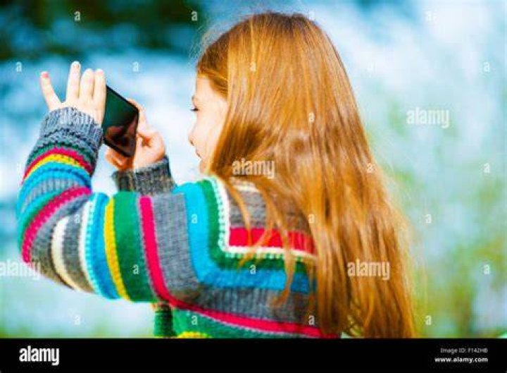 girl taking photo with smartphone