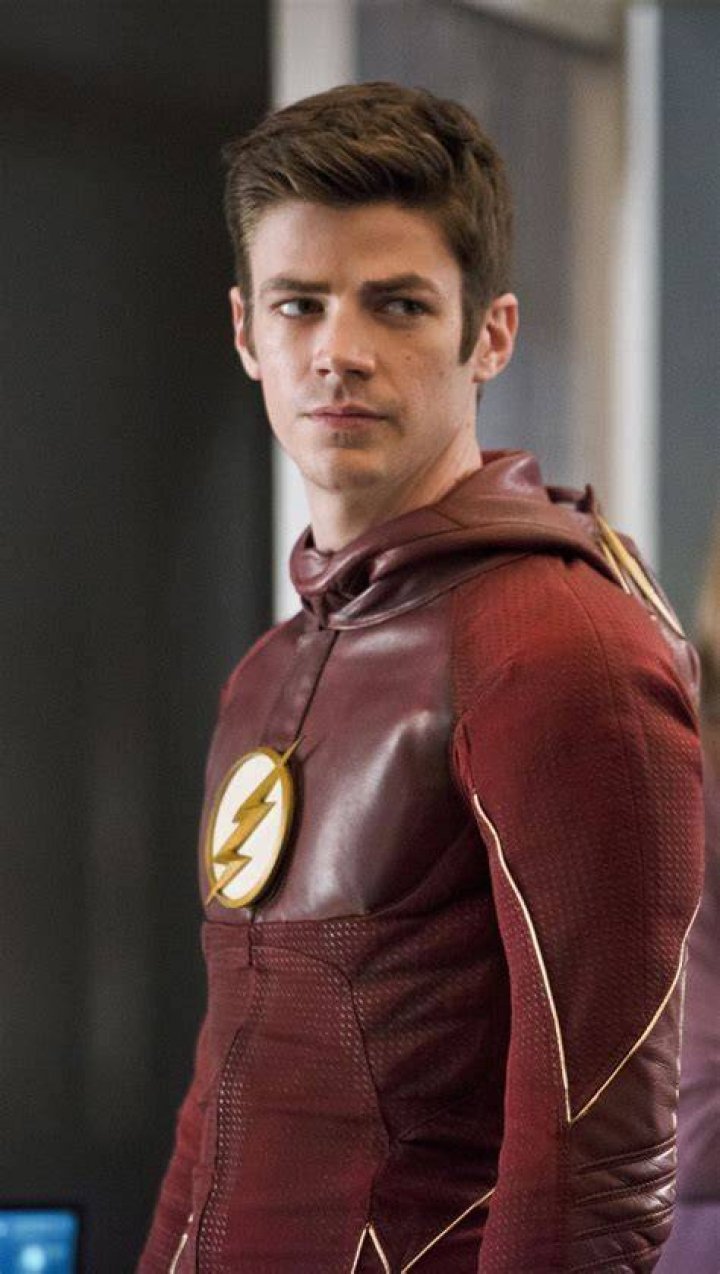 Grant Gustin as The Flash in the CW show next to the official poster