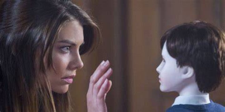 Greta staring at Brahms the doll and holding up her hand in The Boy