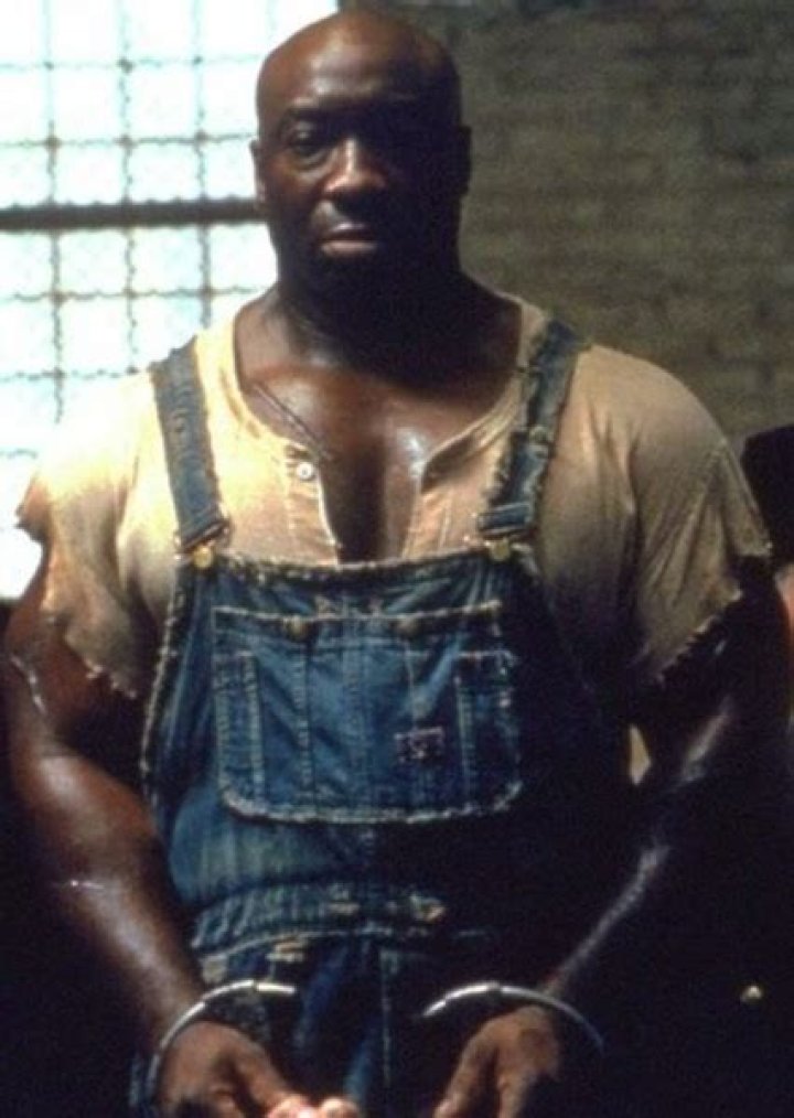 John Coffey points at something and Paul looks on in The Green Mile.