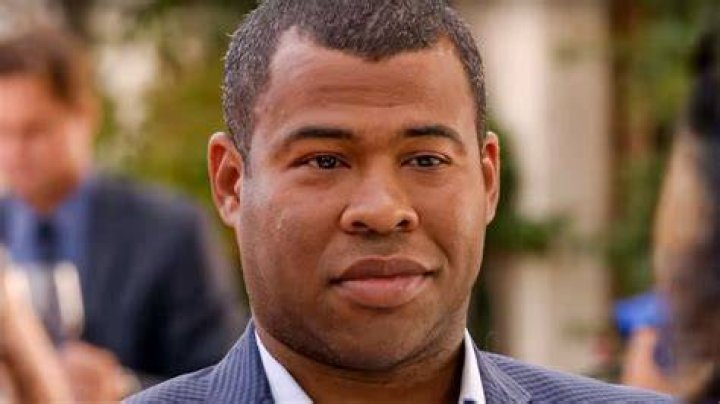 Jordan Peele sitting among a lot of bunnies on the set of Us