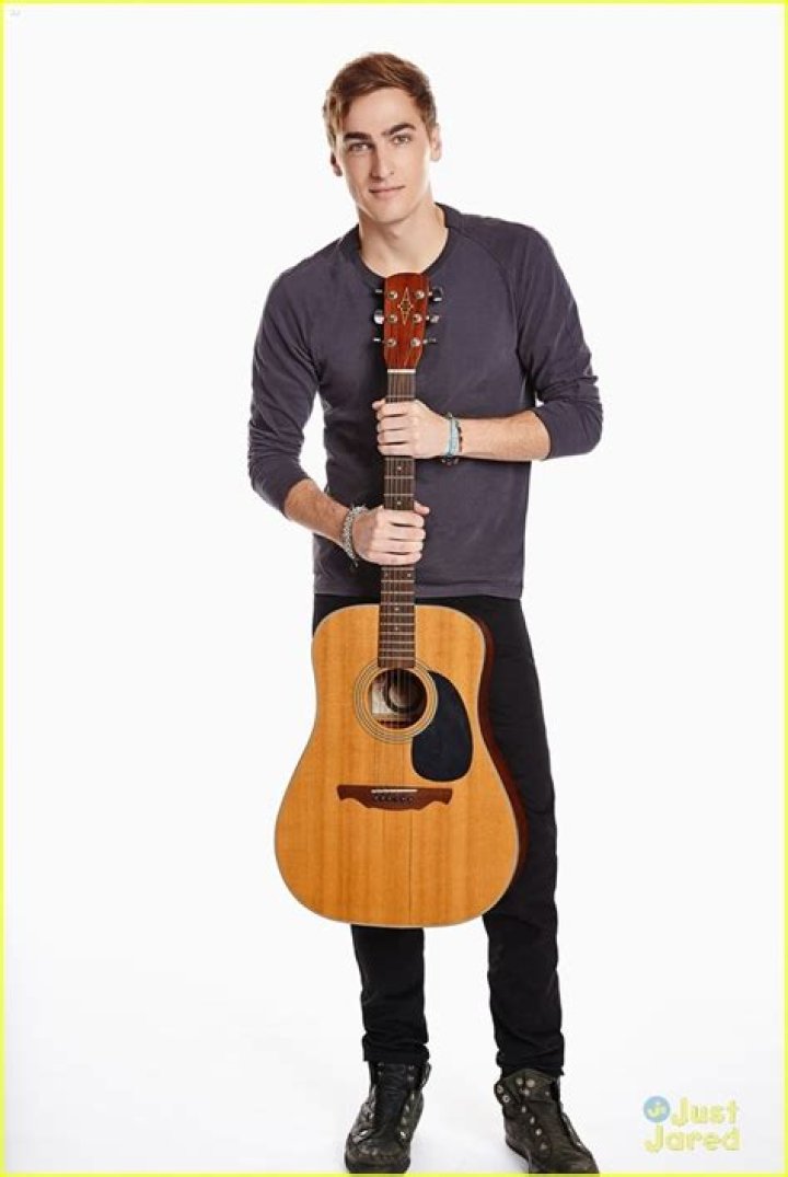 Kendall Schmidt playing guitar