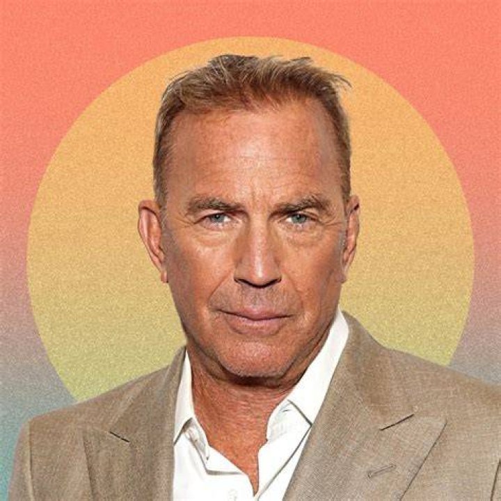 Kevin Costner with his head on top of a ranch fence in Yellowstone