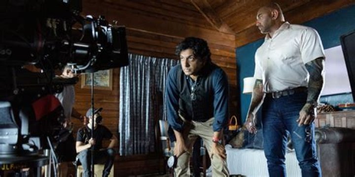 Knock At The Cabin BTS image showing Dave Bautista and M. Night Shyamalan.