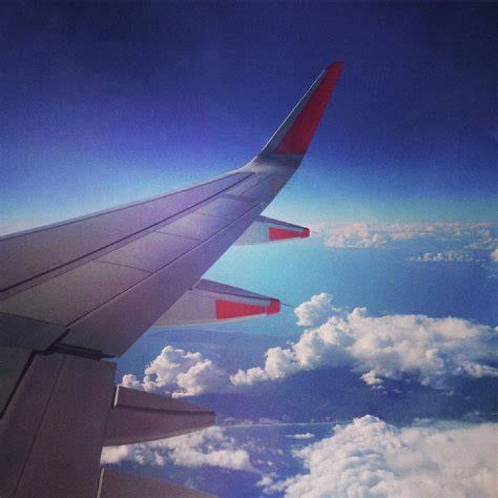 Looking out over the wing of a plane, with another commercial plane in the shot