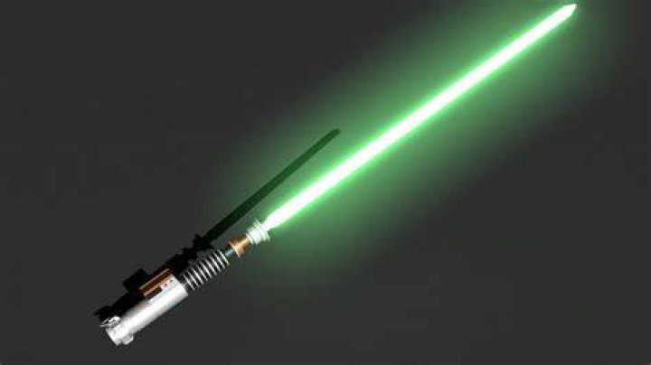 Luke Skywalker using his lightsaber against a training droid on the Millennium Falcon in Star Wars A New Hope