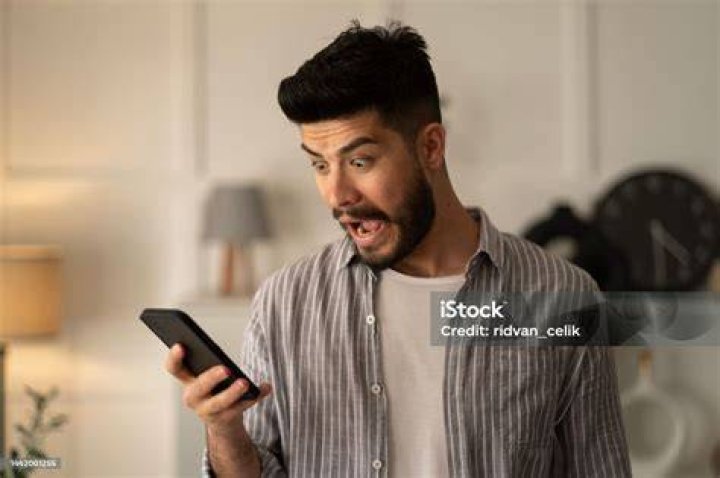 Man holding smartphone read unpleasant sms feels stressed man holding smartphone read unpleasant sms feels stressed