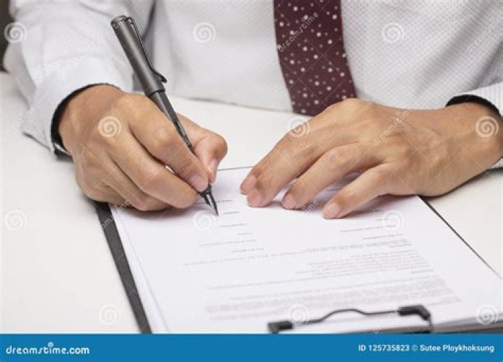 Man signing paperwork