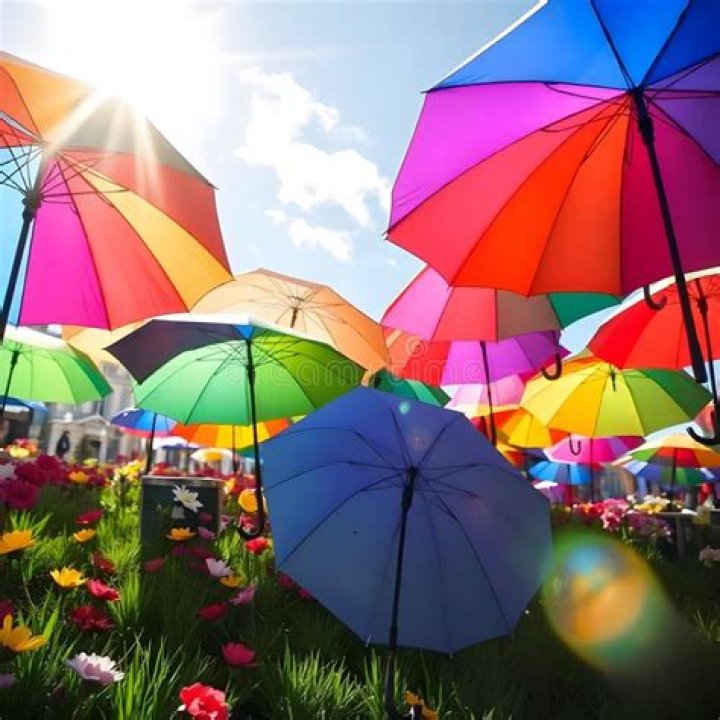 many umbrellas surrounded by bright city signs at night
