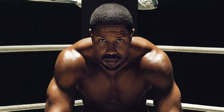 Michael B Jordan in Creed 3 in a boxing gym looking contemplative
