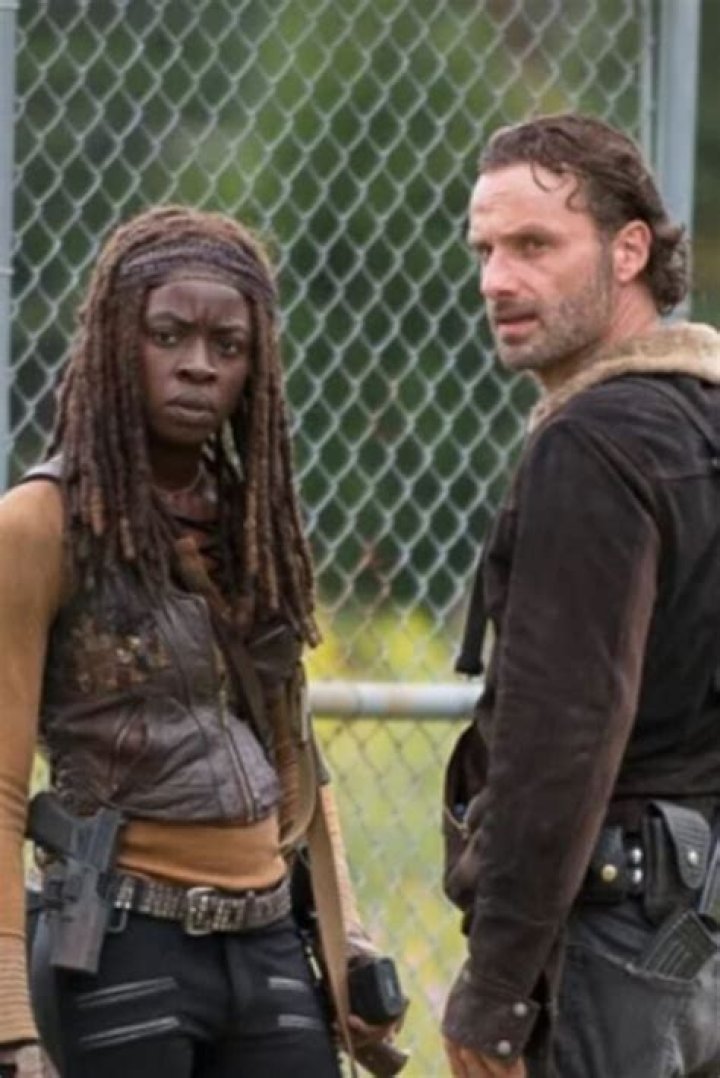 Michonne and Rick stand above an injured Negan in The Walking Dead