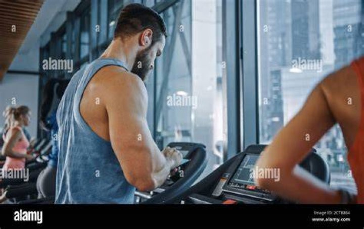 muscular athlete running on treadmill