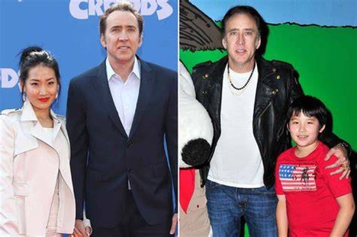 Nicolas Cage and two kids in winter attire riding in an open-air vehicle through a forest setting