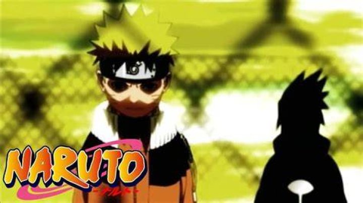 Screenshot from Naruto Opening 5 shows a young Naruto and Sasuke standing with their backs towards one another on a rooftop with a chainlink fence surrounding them.