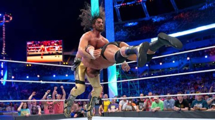 Seth Rollins dives on Triple H