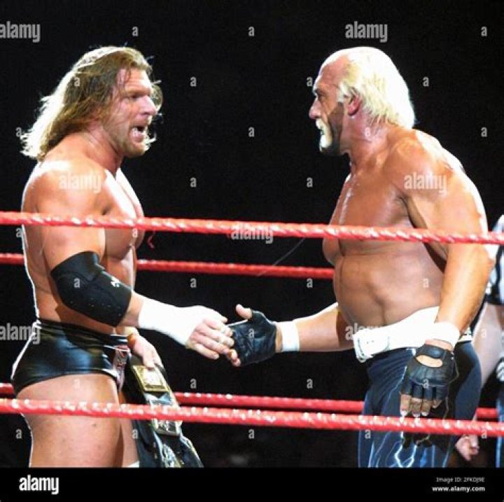 Triple H and Hulk Hogan facing off in the ring