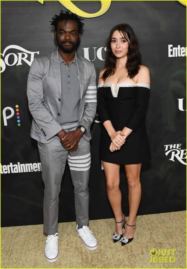 William Jackson Harper and Cristin Milioti as Noah and Emma standing in the grass in in The Resort